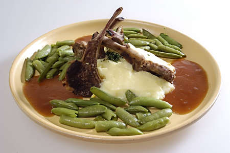 Picture of pork ribs with sauce, stewed vegetables and mashed potatoes.の写真素材