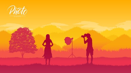 A photographer with equipment makes a photo session with models in nature concept. Take pictures or shoot video in the wild life designのイラスト素材