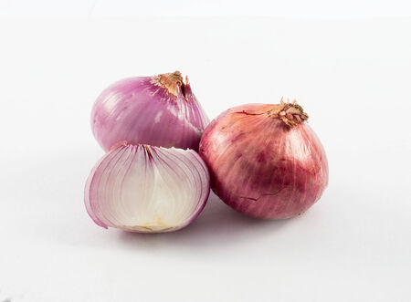 onion and slice of onion isolated on whiteの写真素材