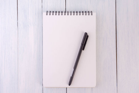 note book,pen,on the desk.top viewの写真素材