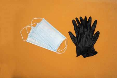 Medical mask and black rubber gloves to protect against infection