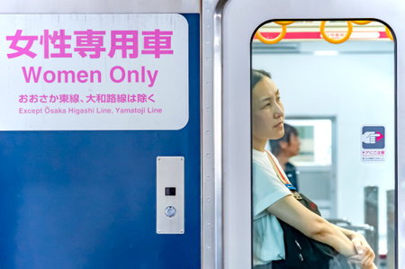Osaka, Japan - 09 10 2019 -Woman on a train in Shin Osaka Station, waiting and thinking, with a sign of Woman Only in the trainのeditorial素材