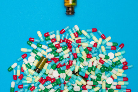 Pharmaceutical and health concept, Variety of antibiotic capsules is spilling out from brown bottle.の写真素材
