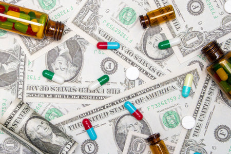 Pharmaceutical and health concept, Antibiotic capsules tablet and brown bottle on dollar background.