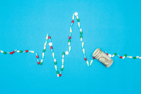 Pharmaceutical and health concept, Antibiotic capsules and tablets arranged in heart wave shape.の写真素材