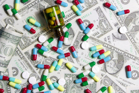 Pharmaceutical and health concept, Variety of antibiotic capsules and pills on dollar background.の写真素材