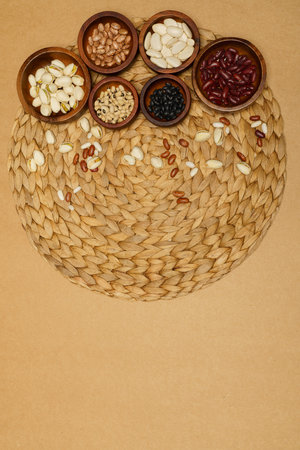 Flat lay of healthy grains concept, Different types of grains in wooden bowl on brown background.の写真素材