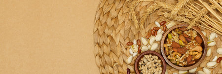 Flat lay of healthy grains concept, Beans in wooden bowl pistachios and wheat on brown background.の写真素材