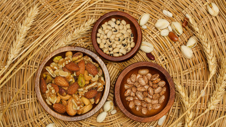 Flat lay of healthy grains concept, Various beans and almond in wooden bowl and wheat on basket.の写真素材