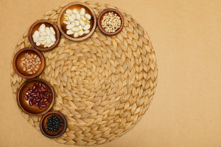 Flat lay of healthy grains concept, Different types of grains in wooden bowl on brown background.の写真素材