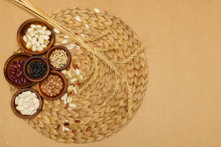Flat lay of healthy grains concept, Wheat and various grains in wooden bowl on brown background.の写真素材