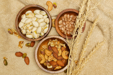 Flat lay of healthy grains concept, Various grains in wooden bowl and wheat on wool blanket.の写真素材