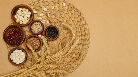 Flat lay of healthy grains concept, Wheat and various grains in wooden bowl on brown background.の写真素材