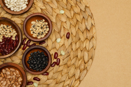 Flat lay of healthy grains concept, Various bean in wooden bowl on brown background.の写真素材