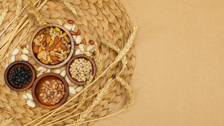 Flat lay of healthy grains concept, Various beans in wooden bowl and wheat on brown background.の写真素材