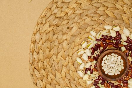 Flat lay of healthy grain concept, Bean in wooden bowl pistachios and beans are arranged in circles.の写真素材