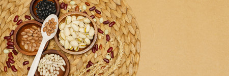 Flat lay of healthy grain concept, Various beans in wooden bowl and wheat on brown background.の写真素材