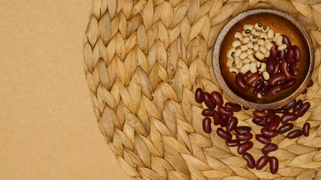 Flat lay of healthy grains concept, Red bean and soybean in wooden bowl on brown background.の写真素材