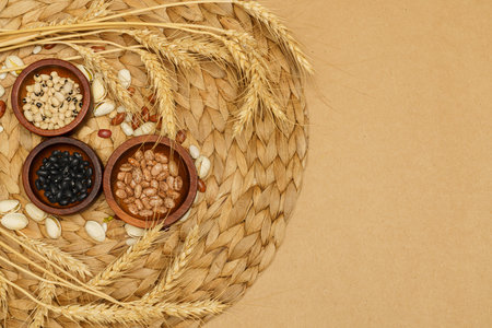 Flat lay of healthy grain concept, Various bean in wooden bowl pistachios wheat on brown background.の写真素材