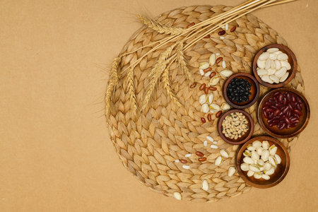 Flat lay of healthy grains concept, Wheat and various grains in wooden bowl on brown background.の写真素材