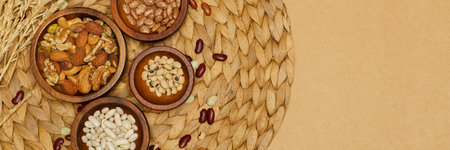 Flat lay of healthy grain concept, Various bean and almond in wooden bowl wheat on brown background.の写真素材