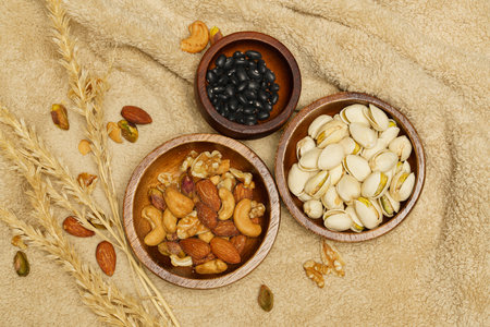 Flat lay of healthy grains concept, Various grains in wooden bowl and wheat on wool blanket.の写真素材