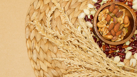 Flat lay of healthy grain concept, Nut almond in wooden bowl wheat and grains on brown background.の写真素材