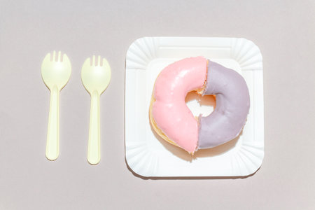 Sweet dessert concept, Delicious pastel donuts in a plate with cutlery on a gray background.の写真素材