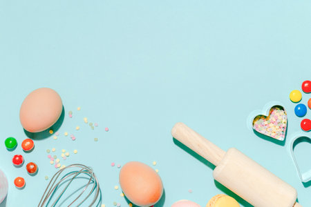 Sweet dessert concept, Various confectionery tools and candy macarons on light blue background.の写真素材