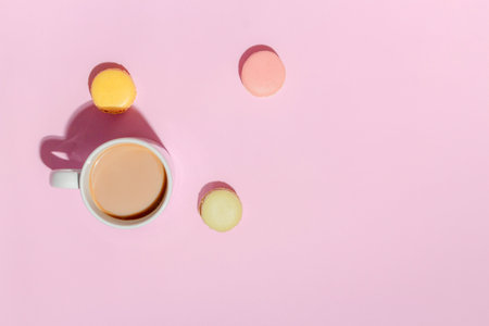 French dessert concept, Colorful macarons in pastel tone and hot coffee on pink background.の写真素材