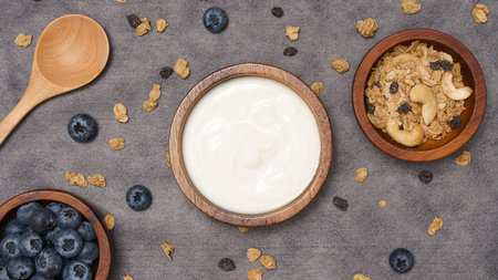 Healthy lifestyle concept, Yogurt fresh blueberry and granola served in bowl over grey background.の写真素材