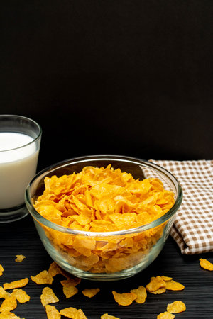 Healthy breakfast concept, Cornflakes in glass bowl and milk in glass with gingham cloth.の写真素材