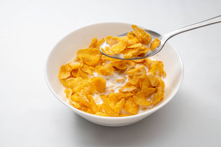 Healthy food concept, Cornflakes and milk with spoon in bowl for breakfast meal.の写真素材