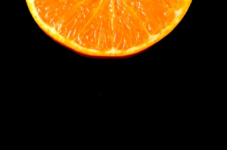 Fresh orange on a black backgroundの写真素材