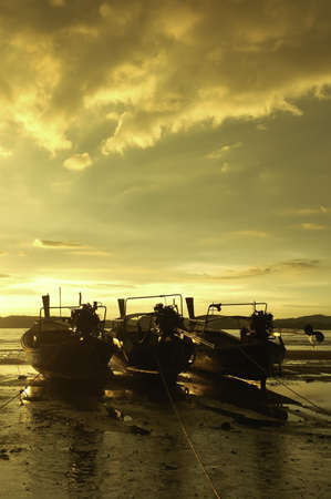Fishing boats and the sea in the evening and sunsetの写真素材