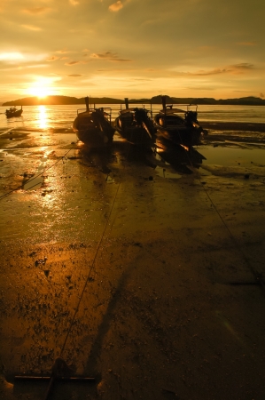 Fishing boat on a sea coast at the sunrise in morning Thailandの写真素材