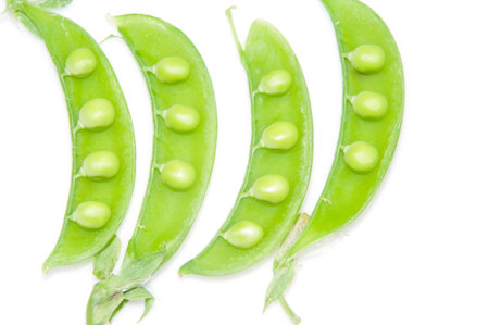 Fresh green peas on a white background