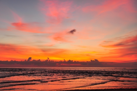 Silhouettes on the beach and beautiful skyの写真素材