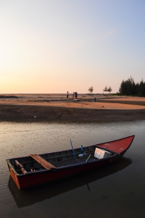 Fishing boat at beach and sunsetの写真素材