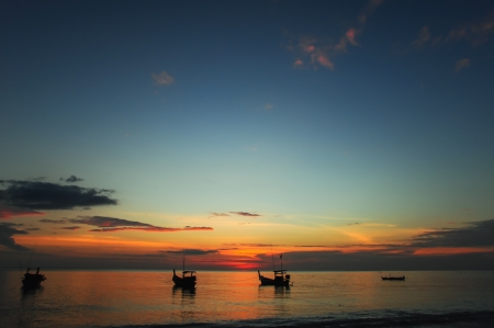 Small fishing boat, beach and sunsetの写真素材