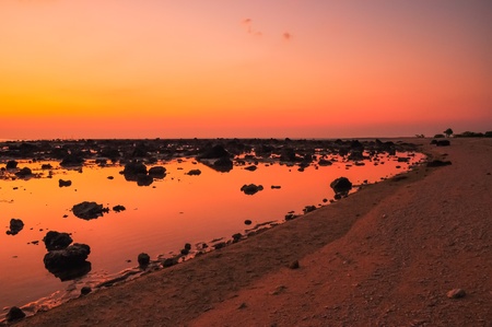 Rocky beach and the evening sky の写真素材