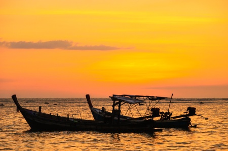 Fishing boats at the beach in the eveningの写真素材
