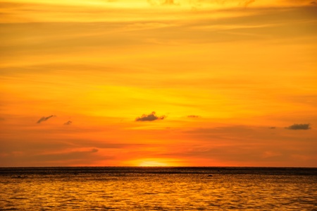 sunset at the beach and the sky orangeの写真素材