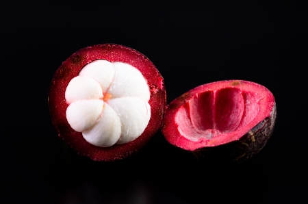 Mangosteen fruit on black backgroundの写真素材