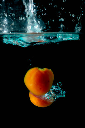 Tomato water splash on black backgroundの写真素材