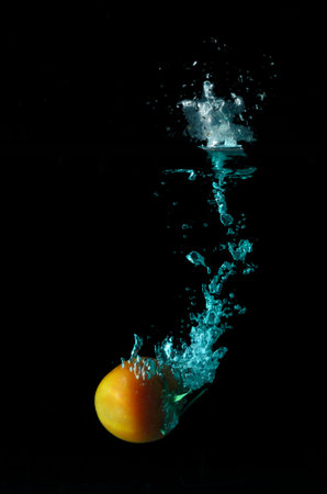 Tomato water splash on black backgroundの写真素材