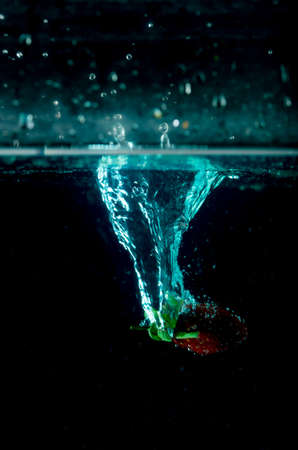 strawberry water splash on black backgroundの写真素材