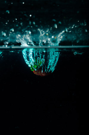 strawberry water splash on black background