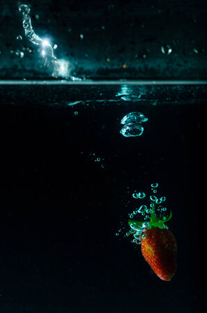 strawberry water splash on black backgroundの写真素材