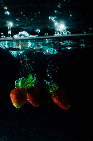 strawberry water splash on black backgroundの写真素材